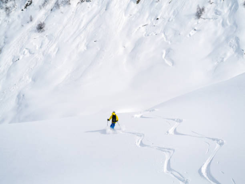  A skier moving down on a steep slope