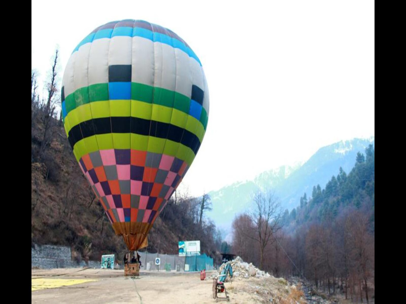 A hot air balloon is rising in the air at Gulmarg