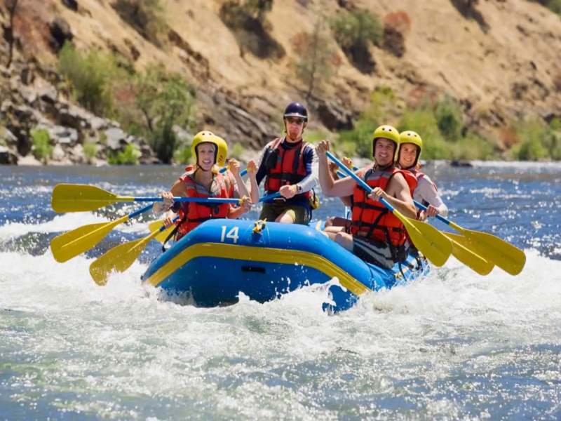 A group of tourists are cherishing the sport of river rafting.